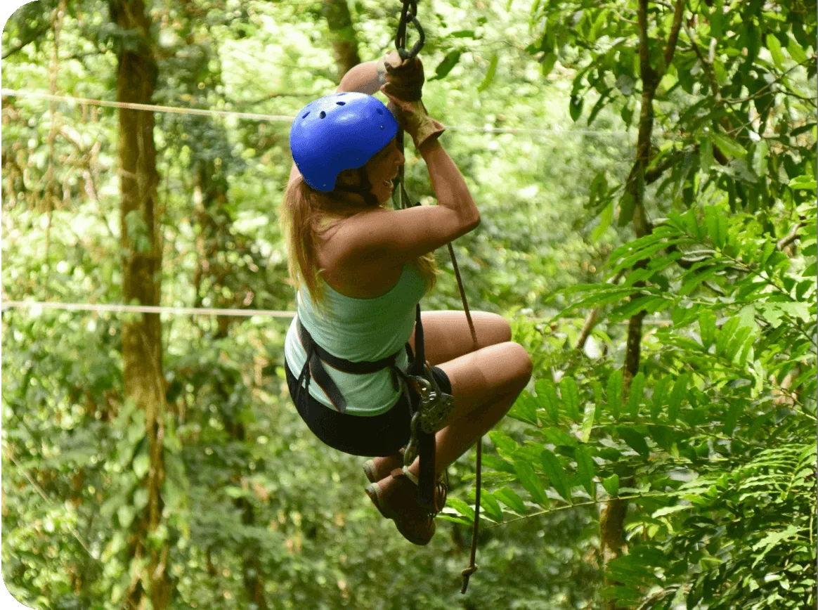 Adventure seeker ziplining through a dense rainforest canopy